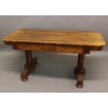 A VICTORIAN ROSEWOOD LIBRARY TABLE the rounded rectangular with frieze drawers on trestle ends;