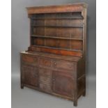 AN OAK DRESSER the back with open shelves and small drawers, the base with drawers & cupboards; 18/