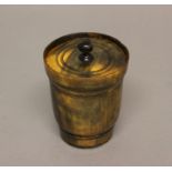 A 19TH CENTURY HORN TOBACCO BOX AND COVER. Of turned form with a pull off circular lid with ringed