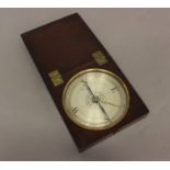 A TRAVELLING COMPASS BY DOLLOND OF LONDON. With a 12cm silvered dial, with a central flower