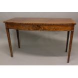 A LATE GEORGE III MAHOGANY BOW FRONT SERVING TABLE. The broad bow fronted top with crossbanded and