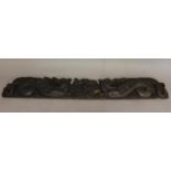 A 17TH CENTURY CARVED OAK 'DRAGON' FRIEZE. Carved in relief with a central armorial flanked by