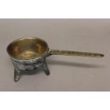 A BRONZE OR BELL METAL SKILLET. AN 18th Century skillet with a straight sided bowl on three legs,
