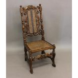 A QUEEN ANNE WALNUT HIGH BACKED CHAIR. With a carved walnut framed with crown centred top rail,