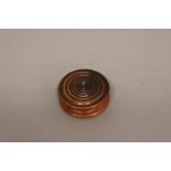 A 19TH CENTURY TURNED WOODEN SEAL BOX. Of circular turned form with ring turned lid and smooth base,