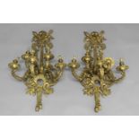 A PAIR OF GILT BRASS WALL LIGHTS OF REGENCY DESIGN each with five branches; 91 cms