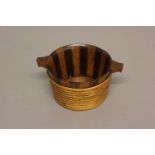 A 19TH CENTURY TREEN 'BICKER' BOWL. The bowl of staved construction with alternating staves of