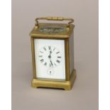 A 19th CENTURY BRASS CASED CARRIAGE CLOCK. With a rectangular white enamelled dial with Roman