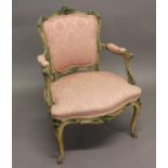 A LOUIS XVI UPHOLSTERED ARMCHAIR. With a carved scrolling frame with upholstered back, seat and