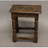 AN OAK JOINT STOOL. With a rectangular top with moulded borer above a lunette carved frieze