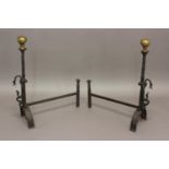 A PAIR OF 18TH/19TH CENTURY BRASS MOUNTED ANDIRONS. Renaissance style andirons with a tall brass