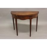 A GEORGE III MAHOGANY TEA TABLE. The demi lune tea table with satinwood strung edges and polished