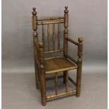 A REPRODUCTION TURNERS CHAIR. Of elaborate turned construction with four rail back between tall