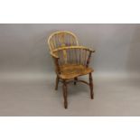 A YEW, BEECH AND ELM WINDSOR ARMCHAIR. A 19th century Windsor armchair with arched back, yew