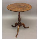 A GEORGE III MAHOGANY TRIPOD TABLE with dished circular top; 58 cms dia.