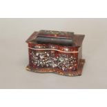 A REGENCY TORTOISESHELL VENEERED TEA CADDY. Of rectangular form with double bowed front and raised