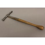 AN EARLY 19TH CENTURY UPHOLSTERERS HAMMER. The steel head with a rounded end and tapering end,