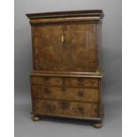 A GEORGE I BURR WALNUT VENEERED FALL FRONT SECRETAIRE CABINET. With a projecting moulded top above a