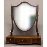 A GEORGE III MAHOGANY DRESSING TABLE MIRROR. With a shield shaped mirror on scrolling uprights