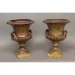 A DECORATIVE PAIR OF STONEWARE CAMPANA SHAPED URNS. A pair of salt glazed urns by Hexter