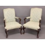 A PAIR OF OPEN ARMCHAIRS IN GEORGE II STYLE the mahogany frames with scrolled arms & carved cabriole