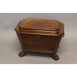 A LATE GEORGE III MAHOGANY WINE COOLER. A sarcophagus form wine cooler with canted corners and broad