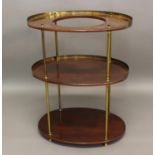 A VICTORIAN CAMPAIGN WASHSTAND the three oval mahogany tiers on brass supports; 70 x 87 cms