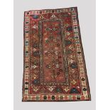KAZAK RUG, CENTRAL CAUCASUS, LATE 19THC. The madder field with four flower head medallions