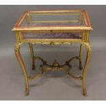 A GILTWOOD DISPLAY TABLE with glazed top and cabriole legs; 63 x 43 cms