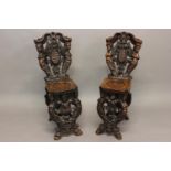 A NEAR PAIR OF VENETIAN STYLE SCABELLO HALL CHAIRS. Each with elaborate scrolling backs with a
