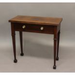 A GEORGE II MAHOGANY FOLD TOP TEA TABLE. The rectangular top above a single frieze drawer with brass