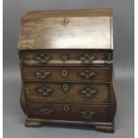 A GEORGE II MAHOGANY BUREAU with fall flap concealing a fitted interior, bombe sides and front