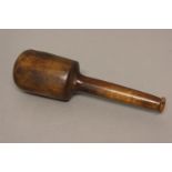 A LATE 17TH OR 18TH CENTURY LIGNUM VITAE PESTLE. With a heavy bulbous end and tapering handle with