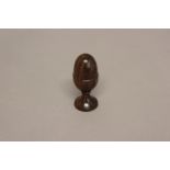A LATE 19TH CENTURY NOVELTY ROSEWOOD EGG CUP. A turned rosewood egg in an egg cup form, 11cm high