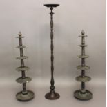 A PAIR OF INDIAN BRASS STANDS each with circular base and five shaped tiers approx. 104 cms high,