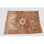 A HERIZ CARPET c1870. Iranian Azerbaijan, The stepped terracotta fields centred by an indigo and