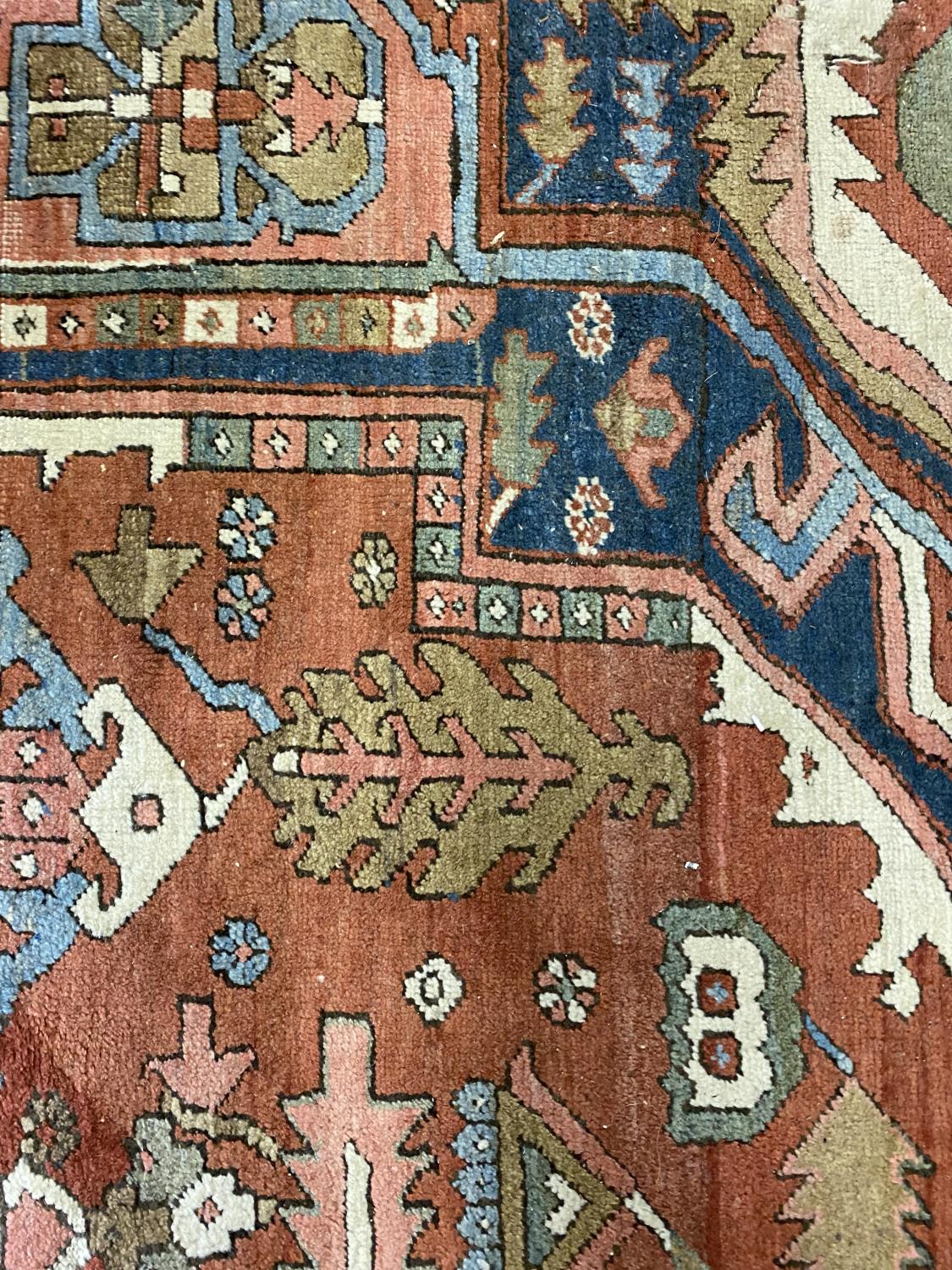 A HERIZ CARPET c1870. Iranian Azerbaijan, The stepped terracotta fields centred by an indigo and - Image 9 of 16