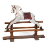 ANTIQUE ROCKING HORSE a painted rocking horse mounted on a wooden trestle stand, fitted with a
