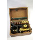CASED MICROSCOPE - SWIFT & SON a brass and metal monocular microscope, in a fitted mahogany case and