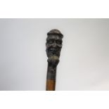 CARVED TOP WALKING STICK the top carved in the form of a gentleman with a long beard, with a metal