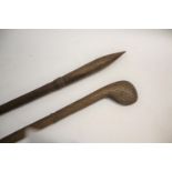 TRIBAL WAR CLUB of pointed form, the shaft with cross hatch carving, 81cms long. Also with another