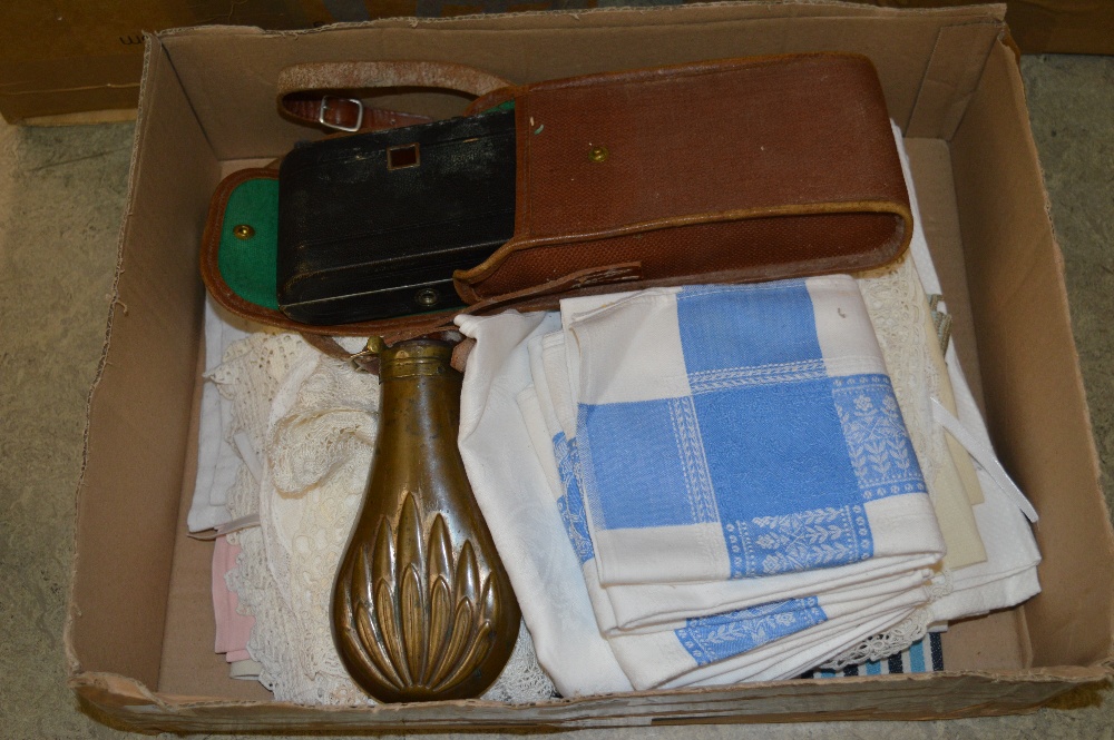 BOX OF ASSORTED LINEN, NAPERY, 19TH CENTURY POWDER FLASK, VINTAGE CAMERA