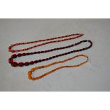 STRING OF BUTTERSCOTCH COLOURED AMBER BEADS, STRING OF RED AMBER BEADS AND SIMULATED FACET CUT AMBER