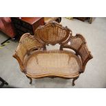 CARVED AND STAINED BEECH WINDOW SEAT IN THE ROCOCO STYLE WITH CANE WORK PANELLED BACK AND KIDNEY