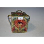 MOORCROFT POTTERY SQUARE SHAPED BISCUIT BARREL AND COVER, DECORATED WITH STYLISED FLOWERS AND