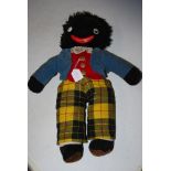 AN EARLY VINTAGE GOLLIWOG CUDDLY TOY WITH DRAWSTRING GROWLER