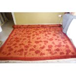 MADDER AND ORANGE GROUND CARPET DECORATED WITH ALLOVER FOLIATE SCROLL DESIGN