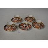 FOUR ROYAL CROWN DERBY IMARI PATTERNED COFFEE CANS AND FIVE SAUCERS