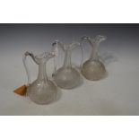 SET OF THREE 19TH CENTURY CLEAR AND FROSTED GLASS EWERS WITH FACET CUT DETAIL TO THE NECKS AND