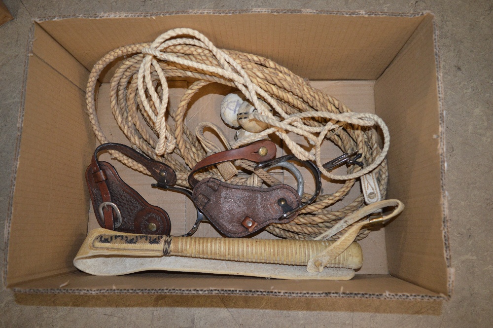 BOX CONTAINING VINTAGE LASSO, SPURS, BELT BUCKLE, THROWING BALLS AND A WHIP